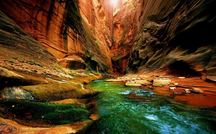 River flowing through a narrow canyon with colorful rock walls