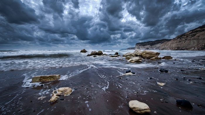 Stormy Beach with Waves and Rocks