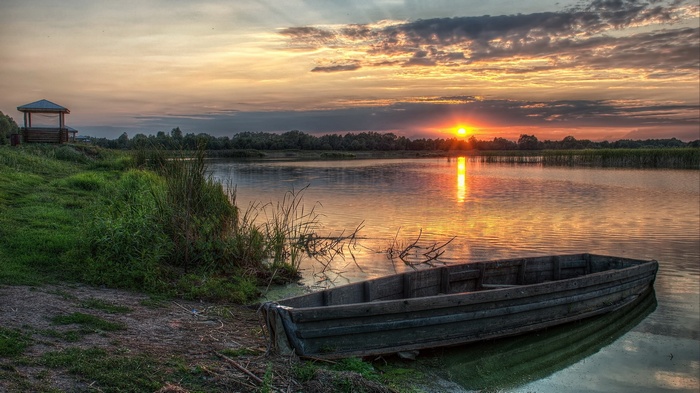 Wooden boat on a lake at sunset