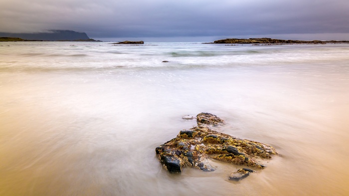 Long exposure of a rocky beach with calm ocean waves