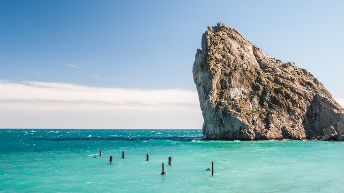Rock formation in the sea under a blue sky
