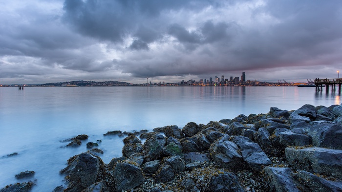 Seattle Skyline Over Water with Rocks and Pier