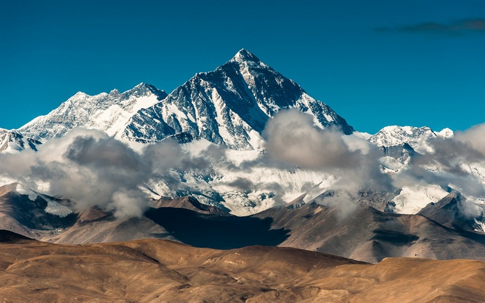 Mount Everest with clouds and brown hills