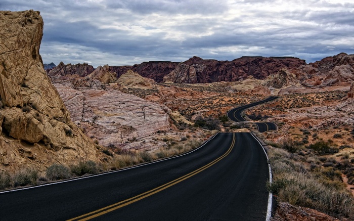 Winding road through desert rock formations