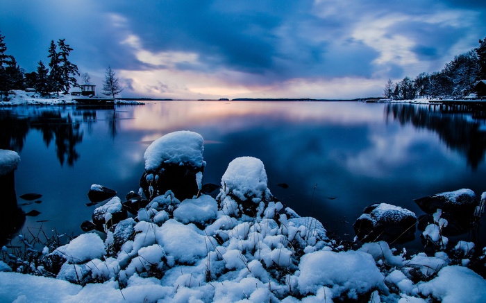 Snowy lake landscape at dusk with reflections