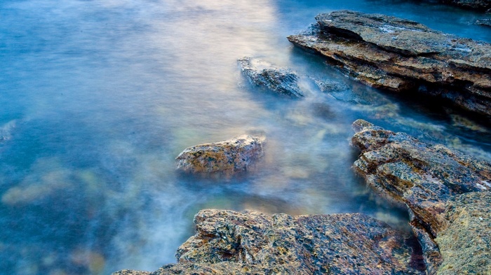 Ocean waves crashing on rocky shore