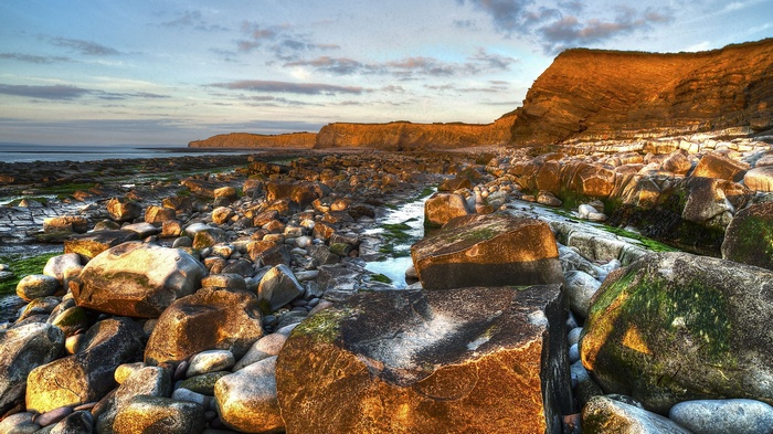 Rocky coastline with cliffs and ocean at sunset