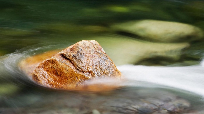 Rock in flowing water