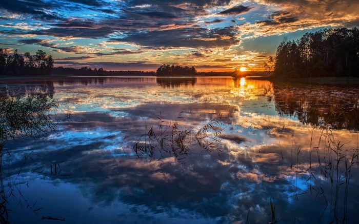 Sunset over a calm lake with reflections
