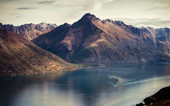 Boat on a lake with mountains in the background