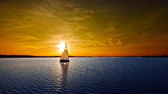 Sailboat on a lake at sunset
