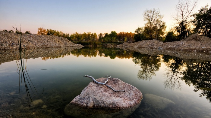 Calm lake with reflections at sunset