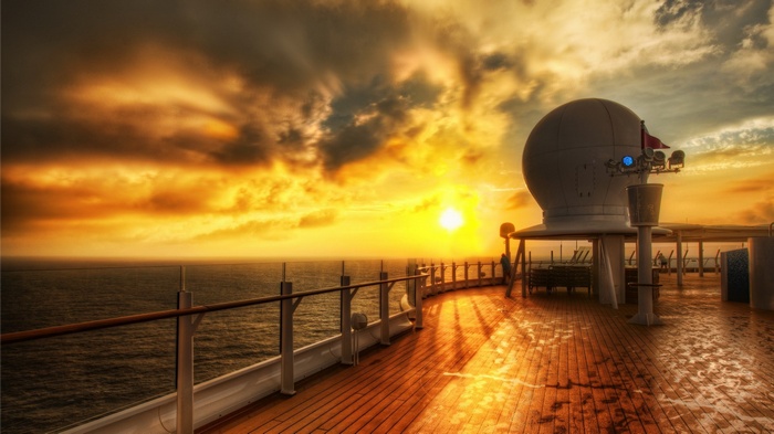 Cruise ship deck at sunset over the ocean