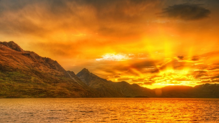 Golden sunset over a lake and mountains