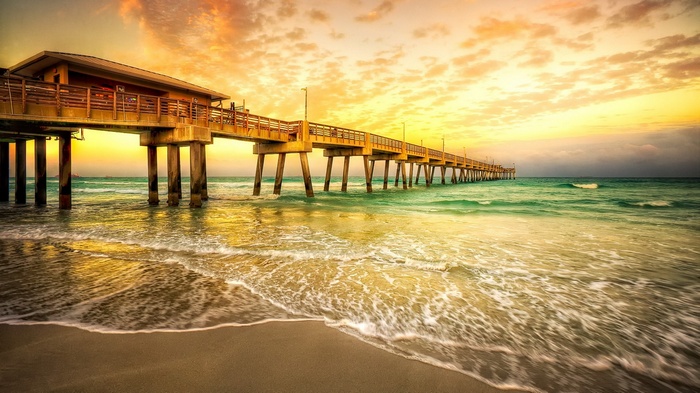 Pier over the ocean at sunset