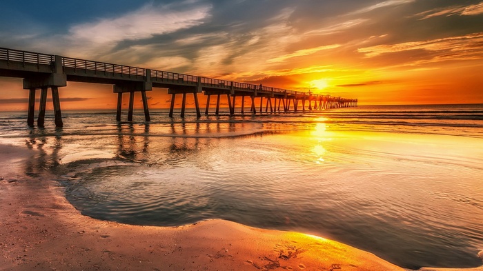 Pier over the ocean at sunset