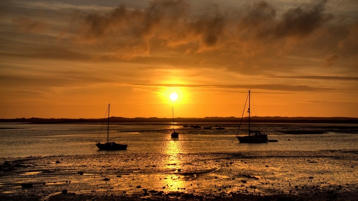 Sailboats at sunset on a calm sea