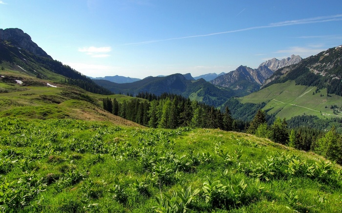 Green mountain landscape with rolling hills and distant peaks
