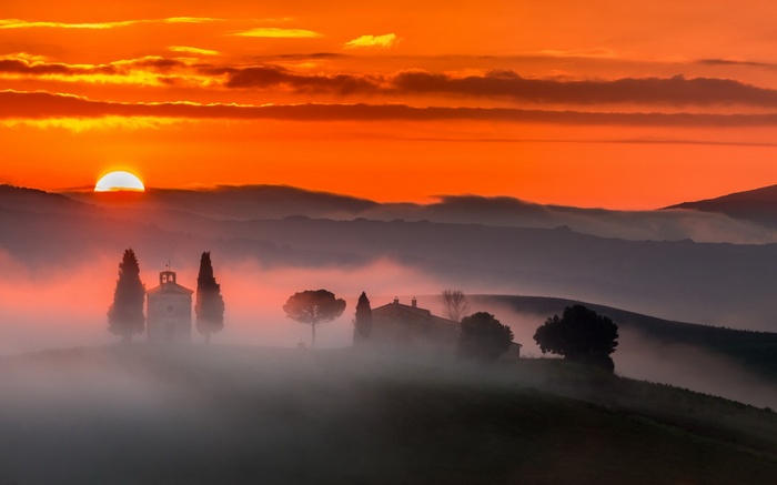 Tuscan landscape with chapel and farmhouse at sunrise