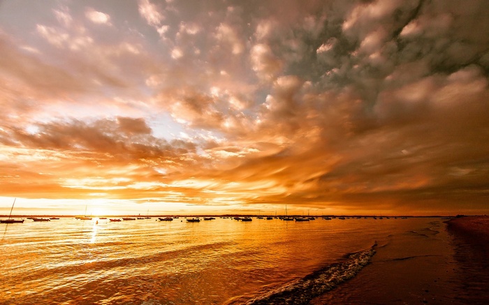 Boats on the water during a vibrant sunset