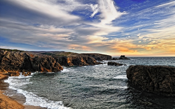 Rocky coastline with waves crashing on a beach