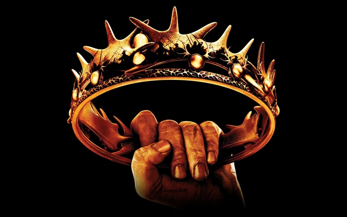 Hand holding a golden crown