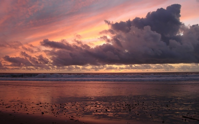 Sunset over the ocean with dramatic clouds