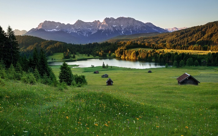 Mountain landscape with lake and small cabins