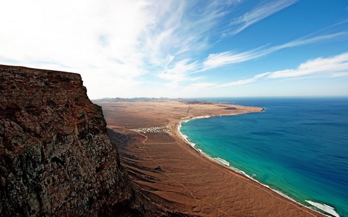 Cliff overlooking a coastal town and the ocean