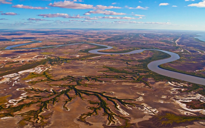 Aerial view of a winding river through a dry landscape