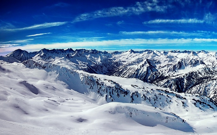 Snowy mountain range under a blue sky