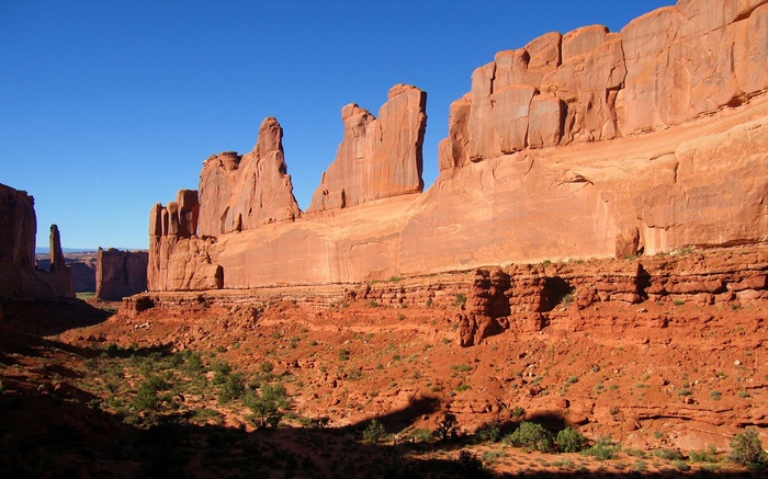 Red rock formations under a clear blue sky