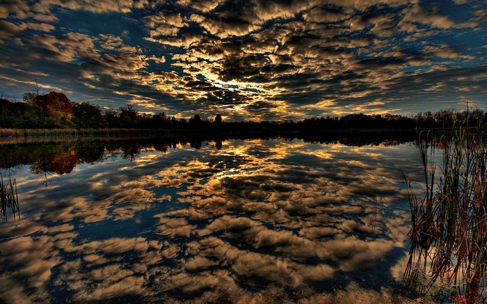 Dramatic sunset clouds reflected in a calm lake