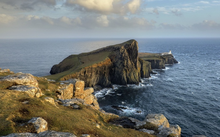 Neist Point Lighthouse on a rocky cliff overlooking the sea