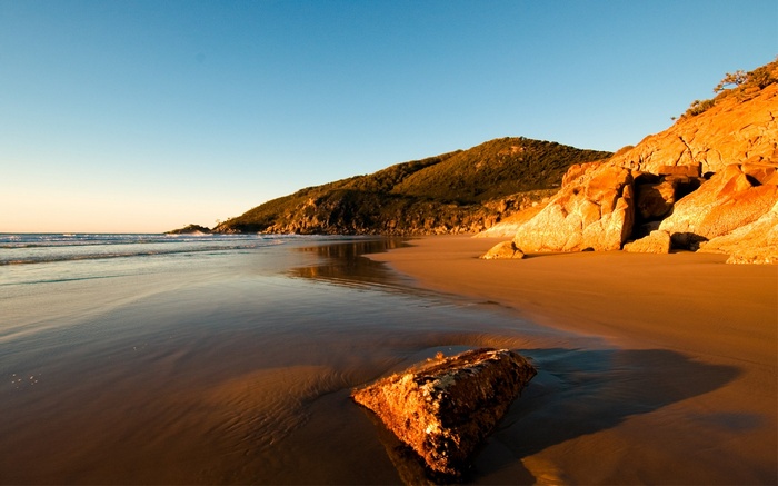 Beach with rocks and ocean at sunset