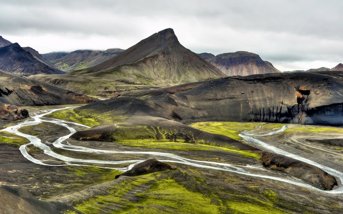 Volcanic landscape with braided river and green moss