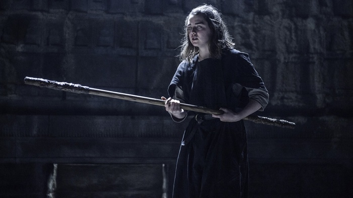 Arya Stark from Game of Thrones with a wooden staff