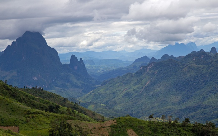 Mountain valley landscape with dramatic clouds
