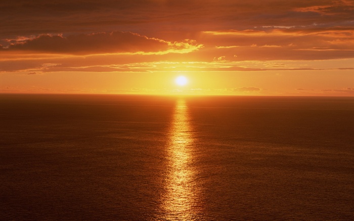 Sunset over the ocean with reflection