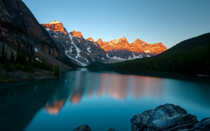 Moraine Lake at sunrise with snow-capped mountains