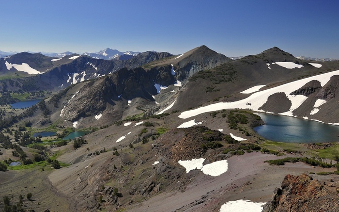 Mountain landscape with lakes and snow patches