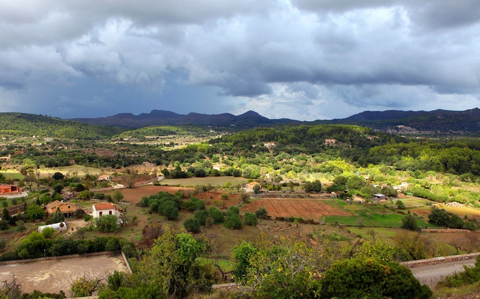 Overcast sky over a rural landscape with houses and trees