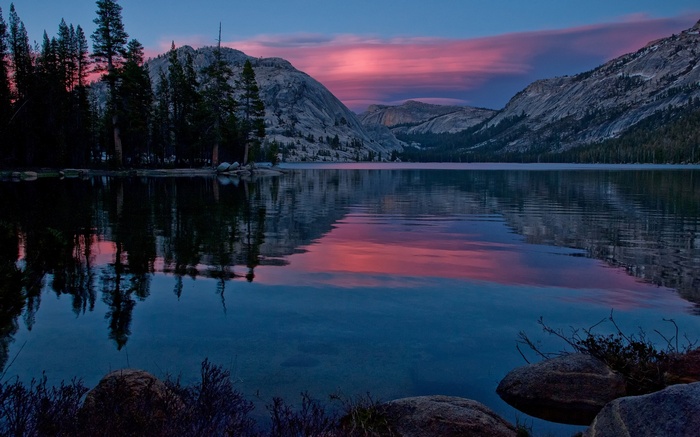 Lake reflection at sunset with mountains and trees