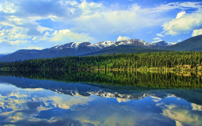 Snow-capped mountains reflected in a calm lake
