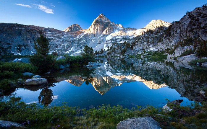 Mountain reflected in a calm lake at sunrise