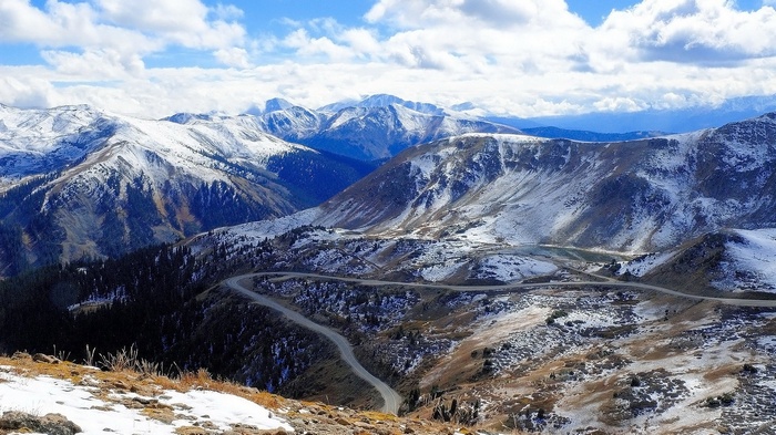 Snow-covered mountains with a winding road