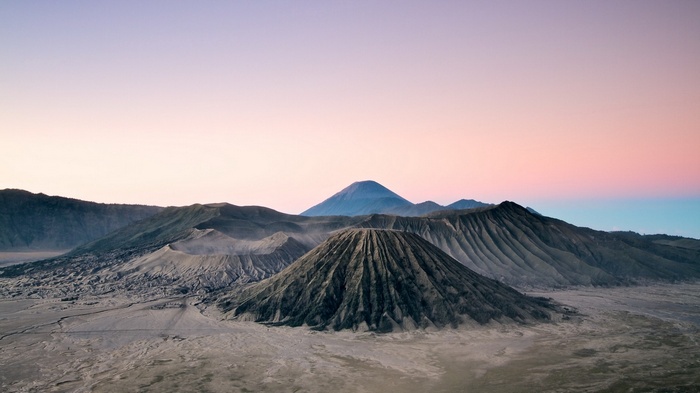 Volcanoes at sunrise with pastel sky