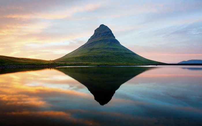 Kirkjufell mountain reflected in water at sunset