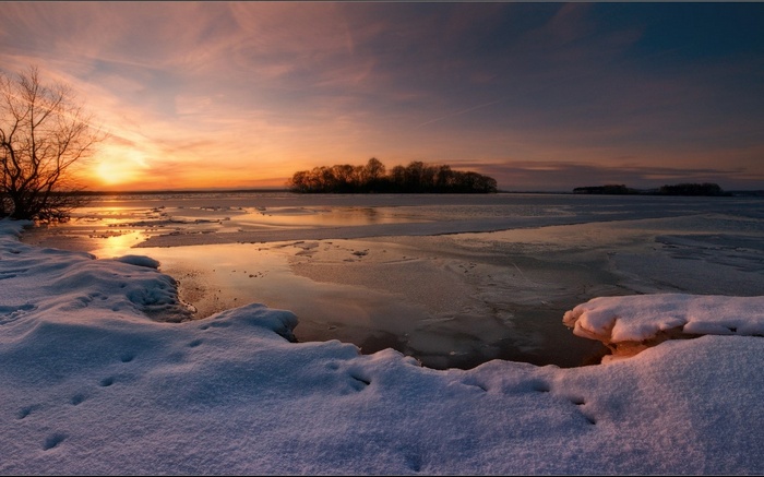 Frozen lake at sunset with island