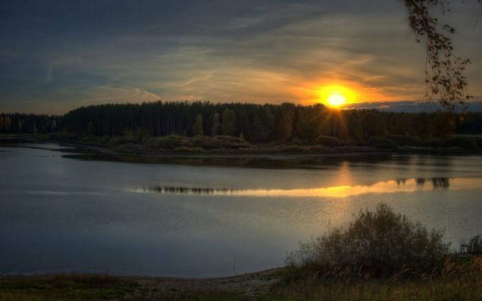 Sunset over a forest and lake